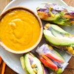 Top photo of Vegan Spring Rolls with coconut sauce.