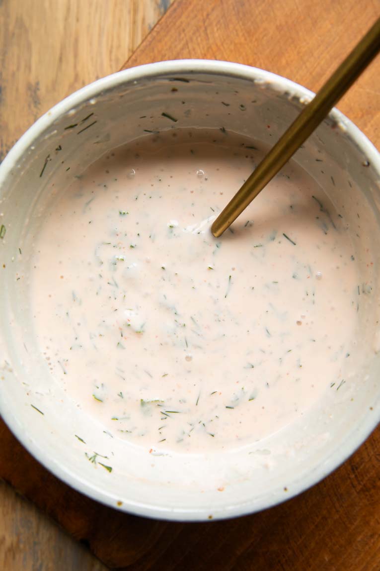 Sriracha ranch dressing being mixed in a bowl.