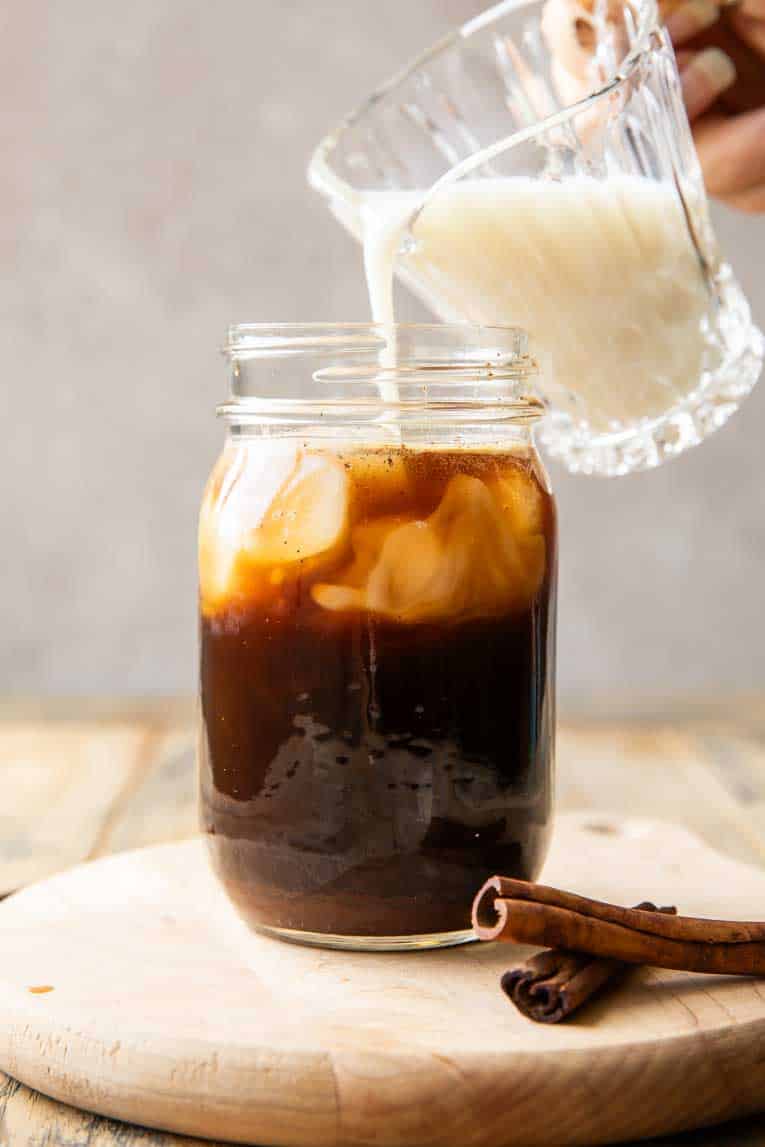 Milk being poured over shaken espresso.