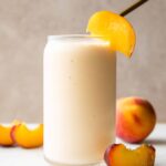 Peach Yogurt Smoothie recipe in a glass with a straw.