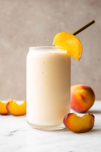Peach Yogurt Smoothie recipe in a glass with a straw.