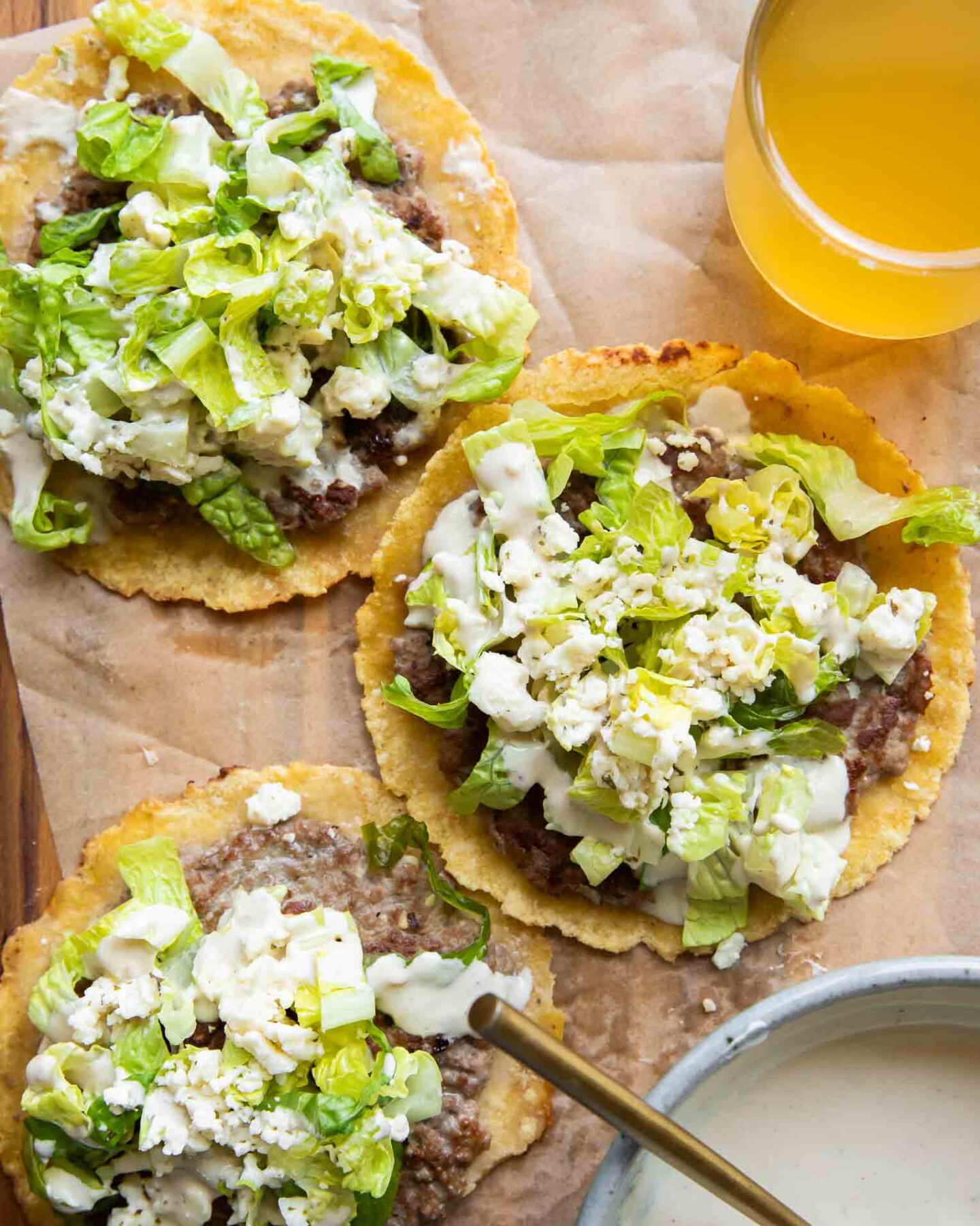 Chicken Caesar Smashed Tacos recipe with a drink and sauce.