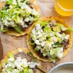 Chicken Caesar Smashed Tacos recipe with a drink and sauce.