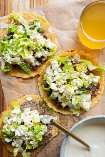 Chicken Caesar Smashed Tacos recipe with a drink and sauce.