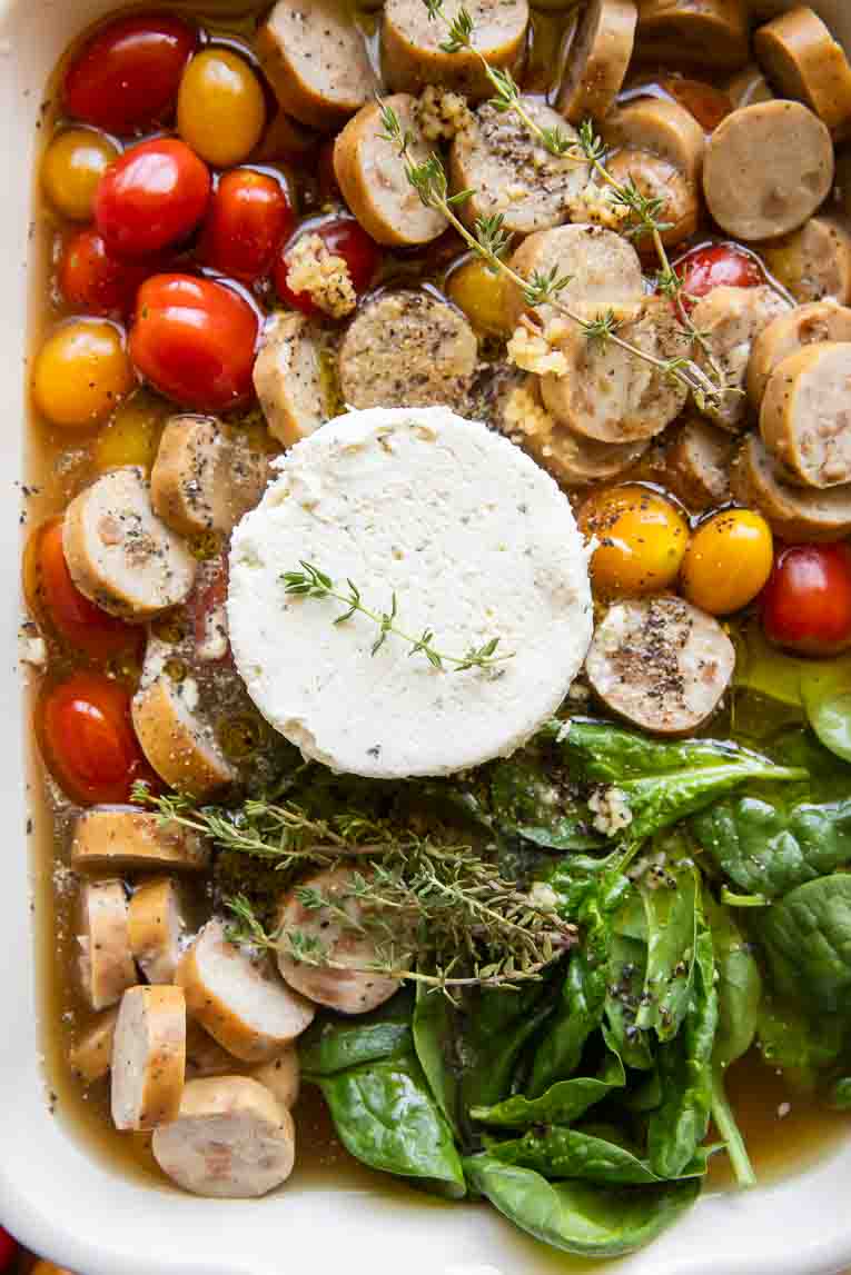 Ingredients for Chicken Sausage Orzo Casserole in a baking dish.