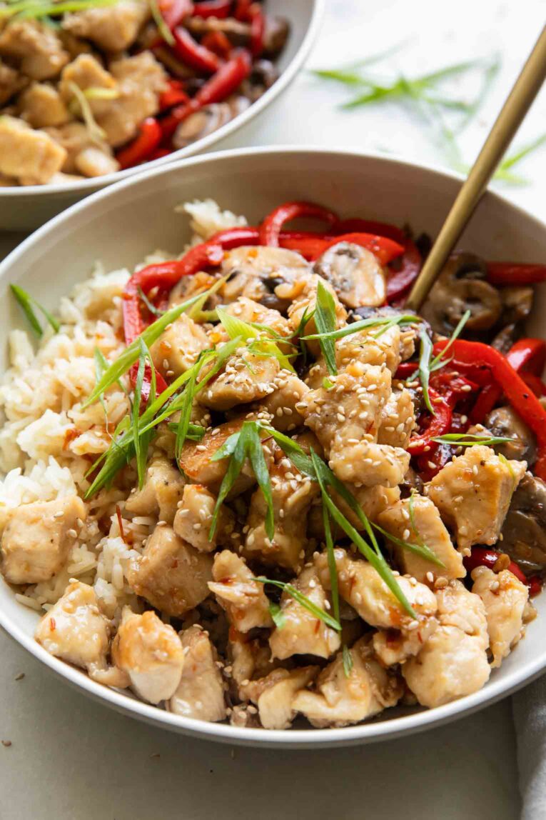 Angled photo of General Taos Chicken with rice and red pepper.