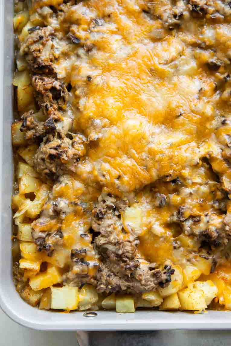 Potatoes, beef, and cheese in a baking dish.