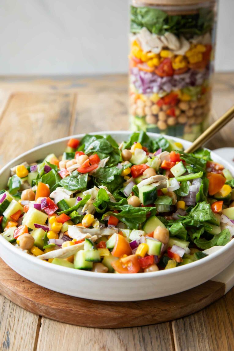 Mason jar salad served in a white bowl.