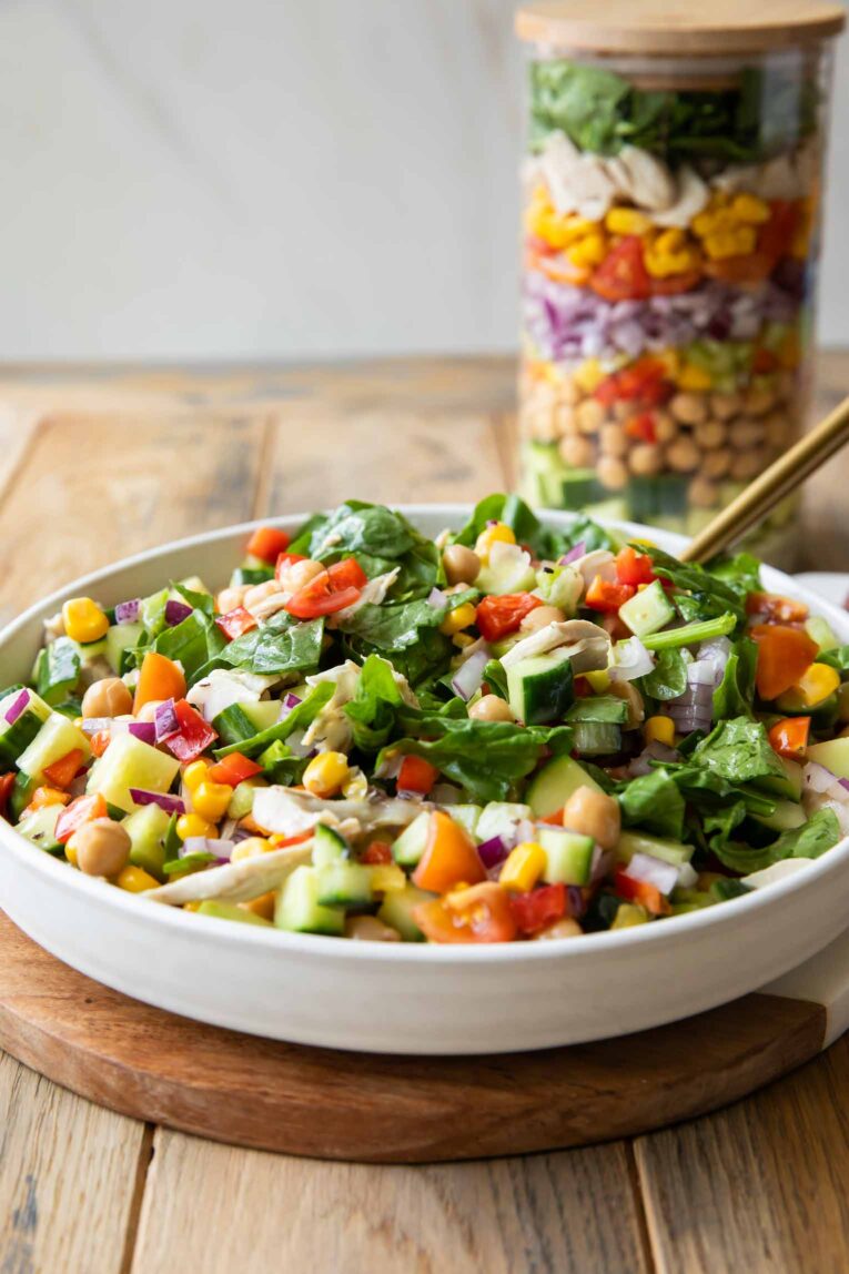 Mason jar salad served in a white bowl.