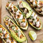 Southwestern Zucchini Boats topped with cream sauce.