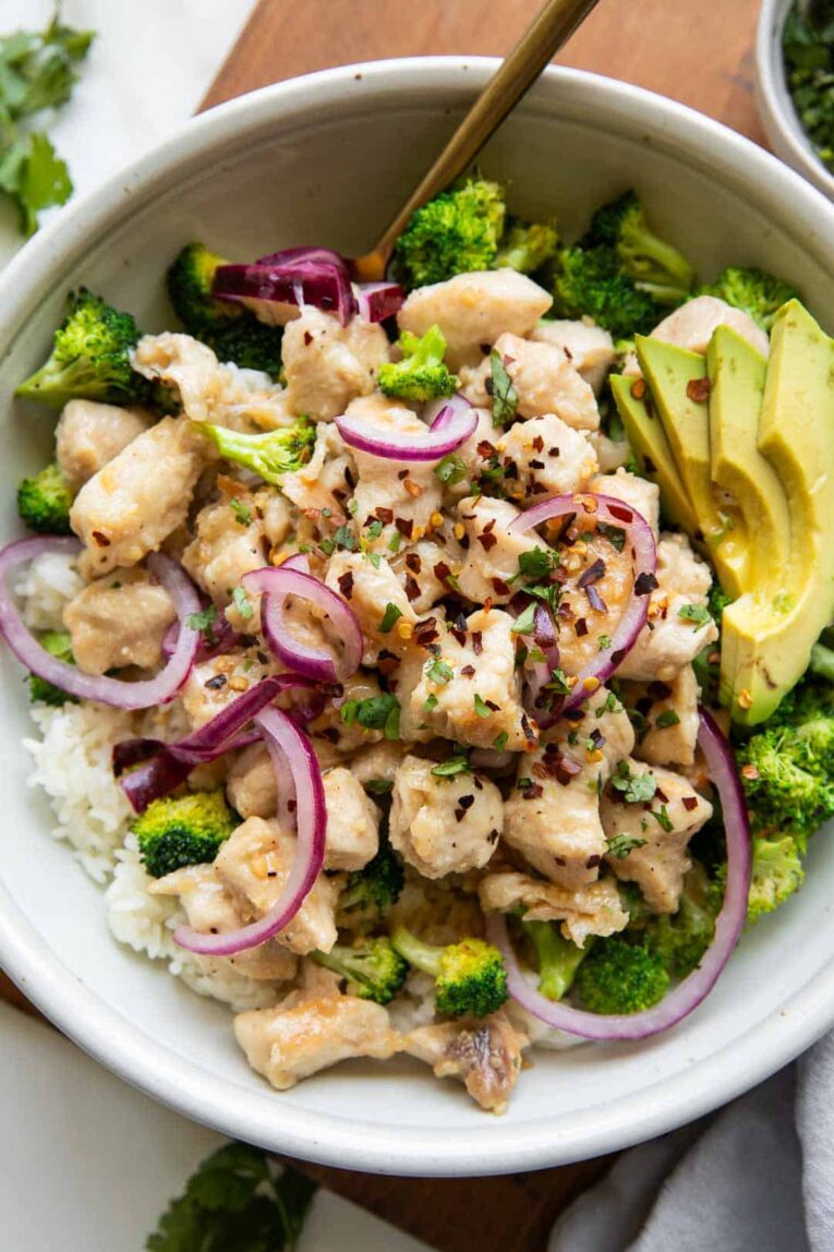 Sticky Garlic Butter Chicken Bowl with avocado and red onion.