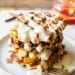 Angled image of Stack of cinnamon roll waffles.