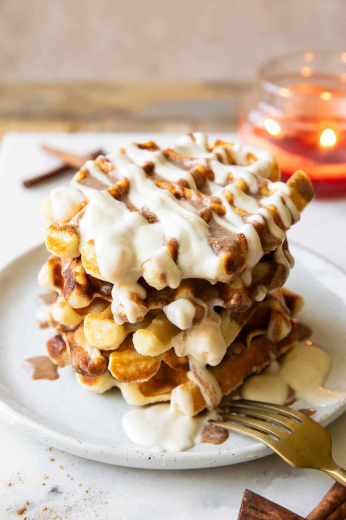 Angled image of Stack of cinnamon roll waffles.