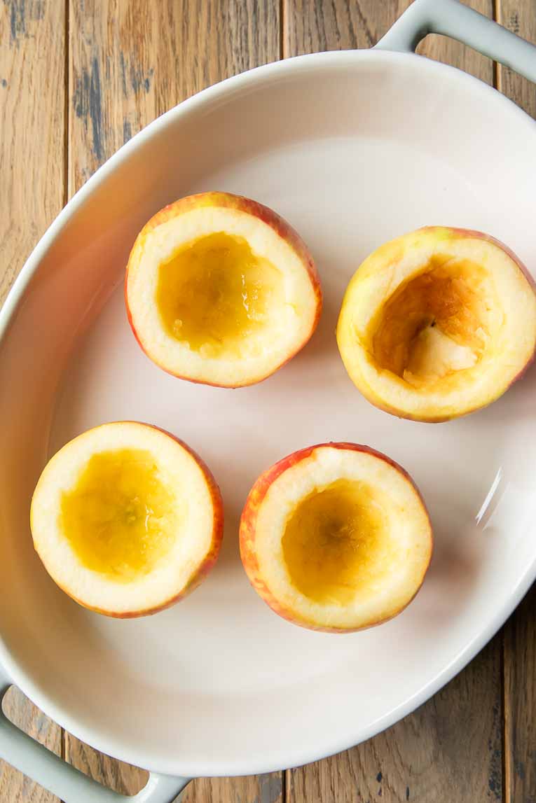 Apples cored on a plate.