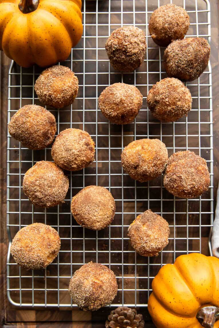 Pumpkin Donut Holes on a cooling rack.