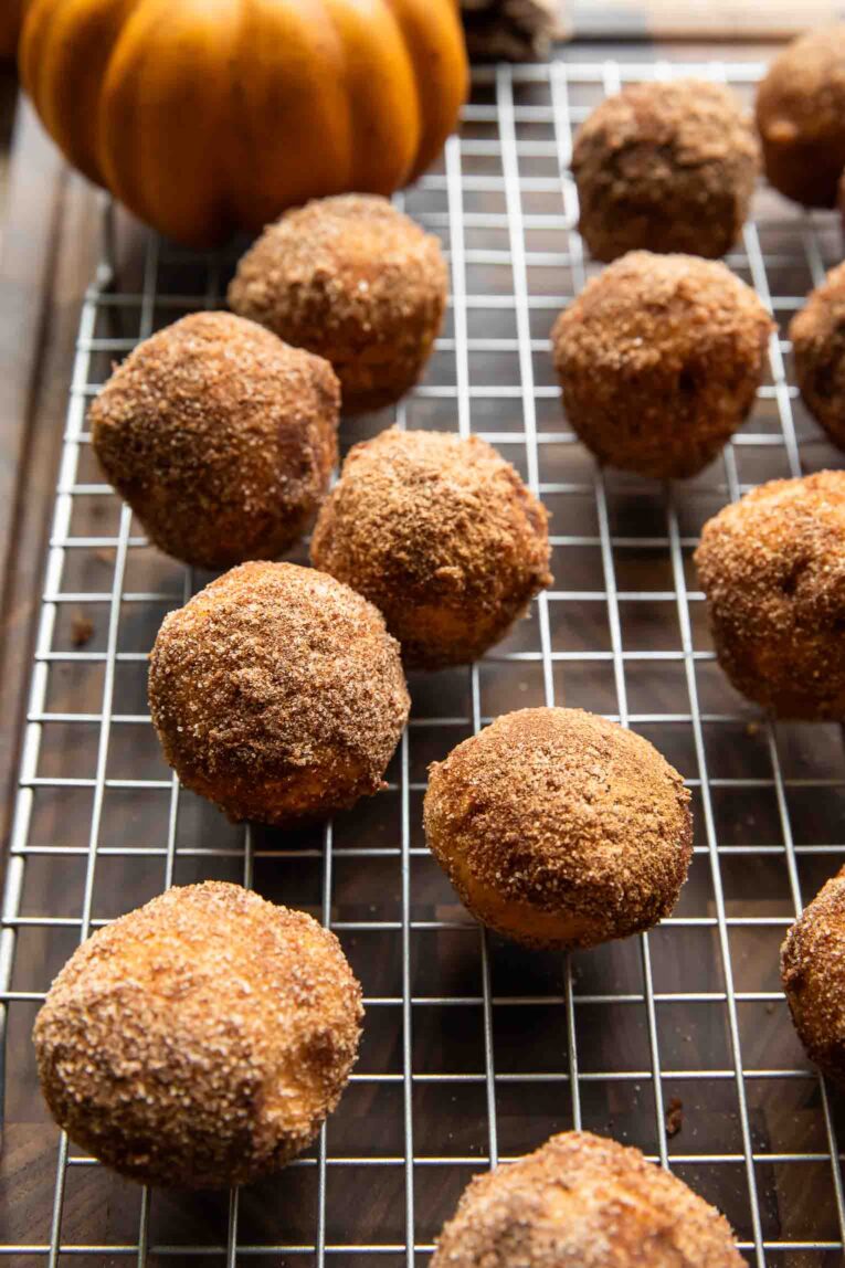 Pumpkin Donut Holes on a cooling rack.