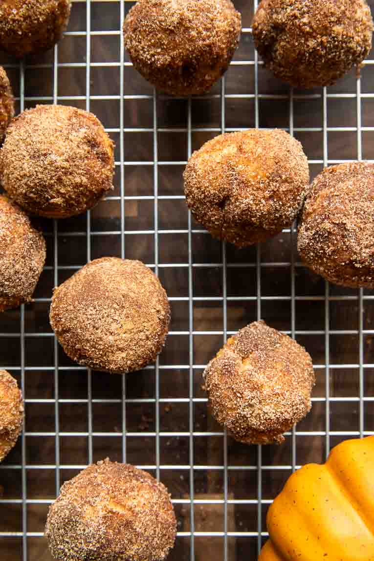 Pumpkin Donut Holes on a cooling rack.