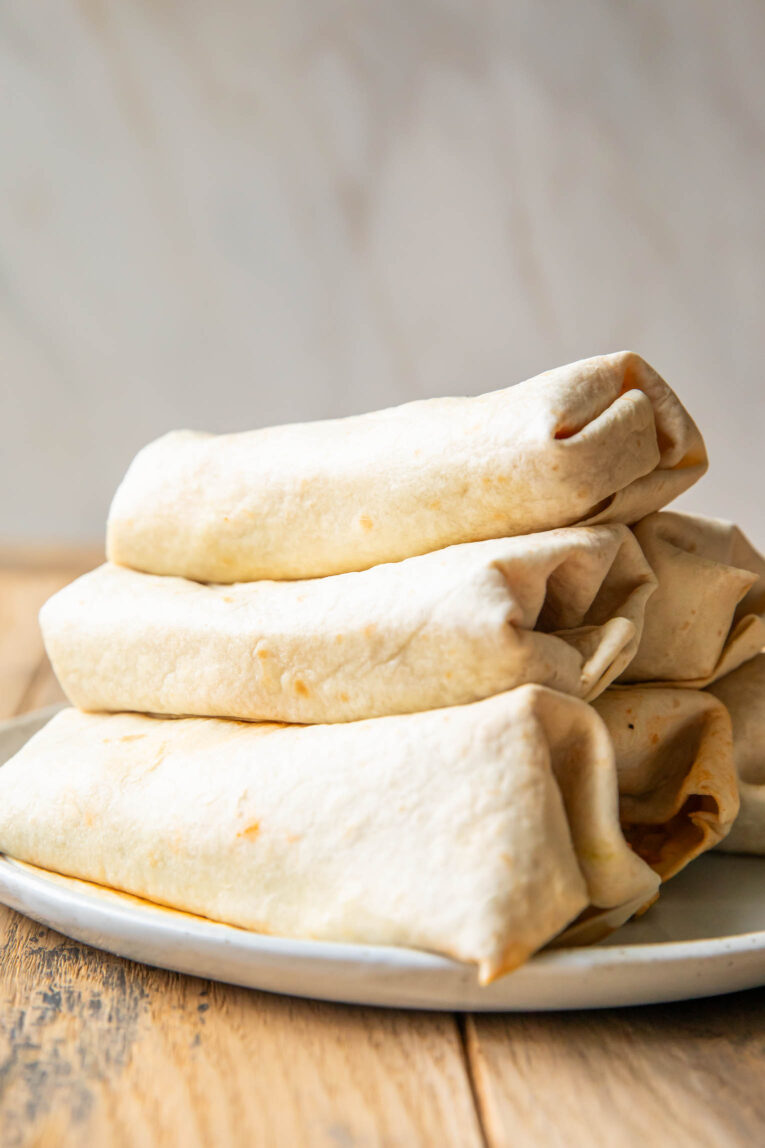Breakfast Burritos stacked on top of each other.