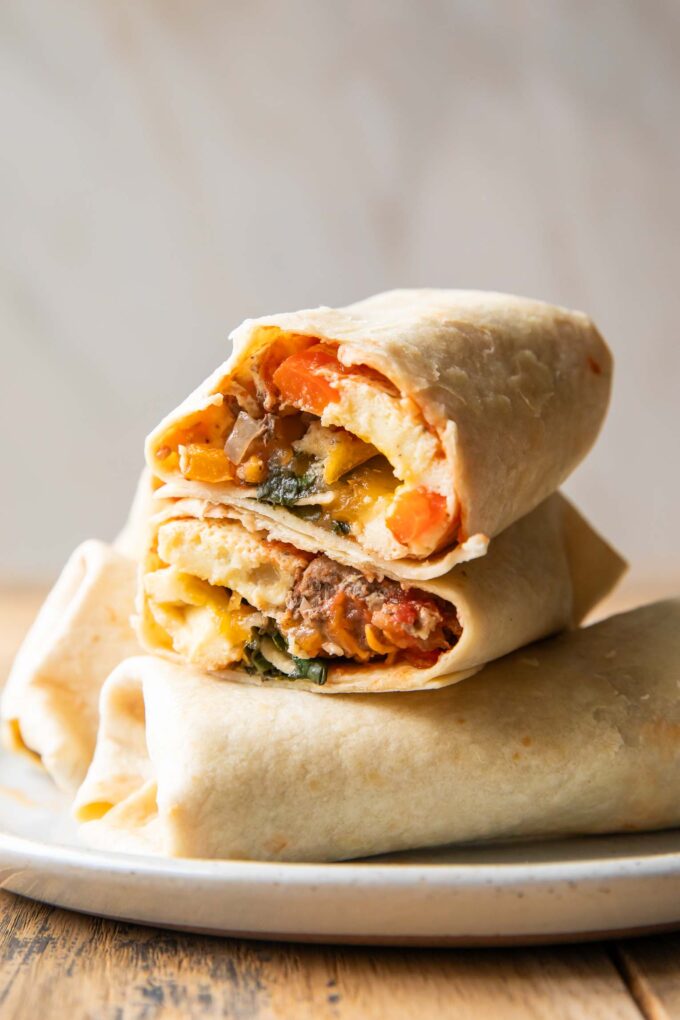 Breakfast Burrito cut in half stacked on top of other burritos.