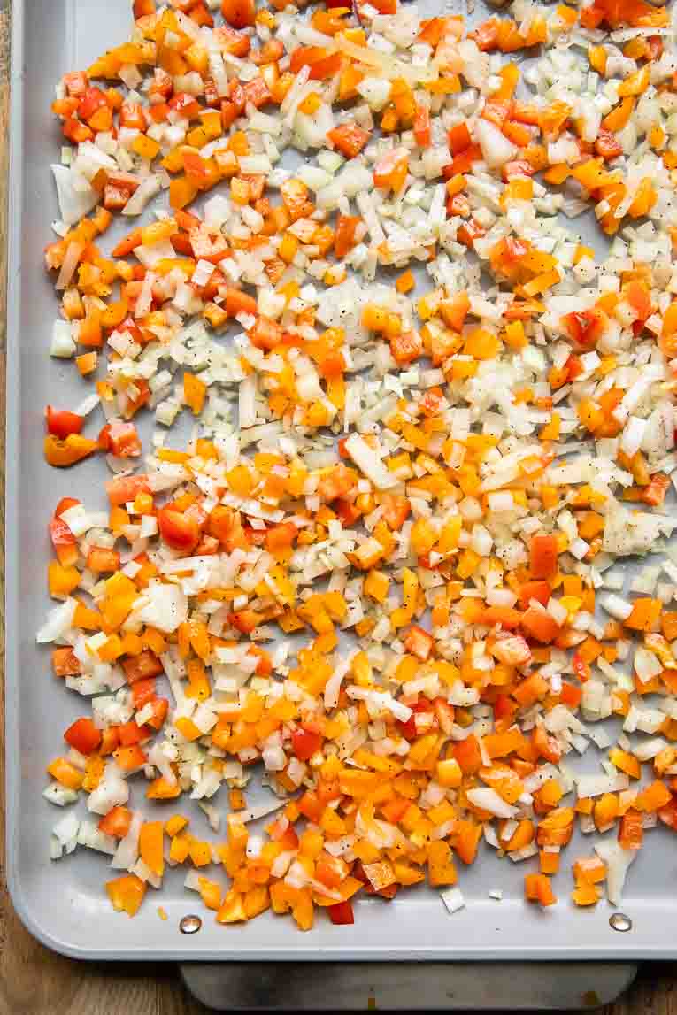 Raw onions & peppers on a sheet pan.