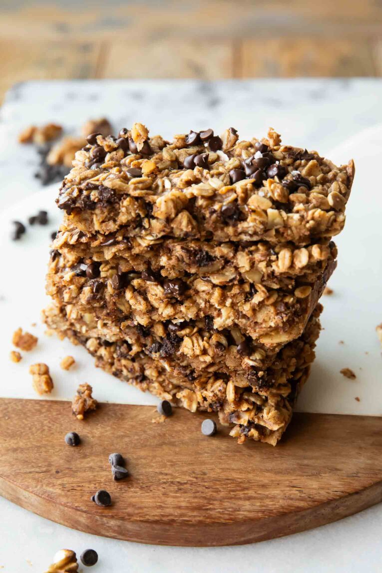 Angled photo of Baked Oatmeal Breakfast Bars stacked on each other.