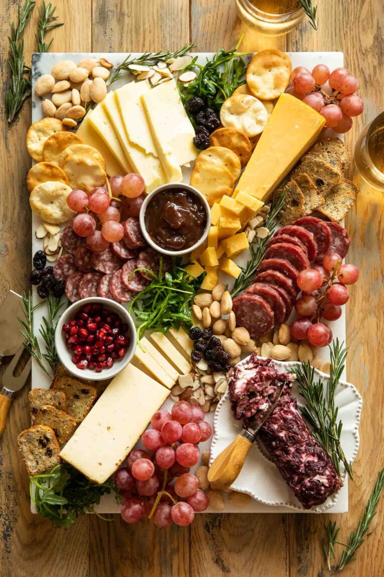 Christmas charcuterie board with meats, crackers, and cheese.