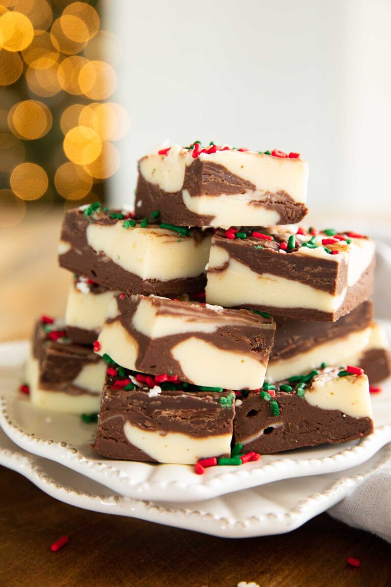 Christmas fudge stacked on a plate.
