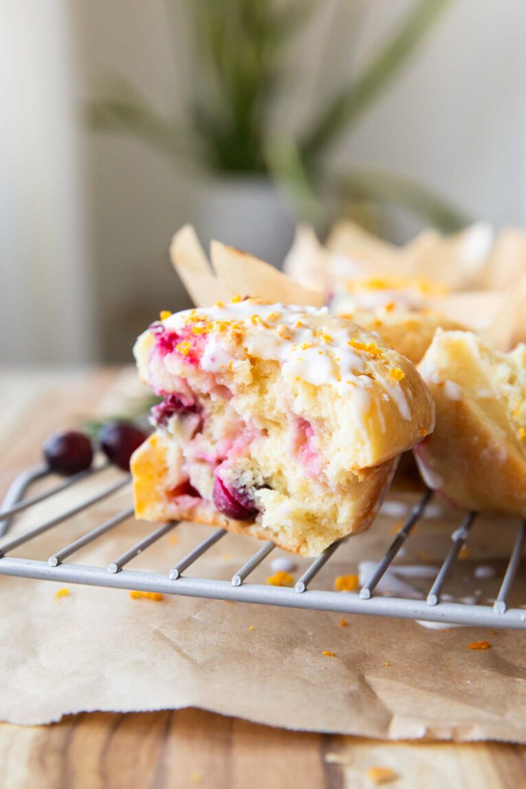 One half of Cranberry Orange Cottage Cheese Muffin on a cooling rack.