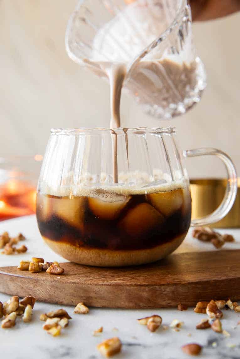Creamer being poured into maple pecan latte.