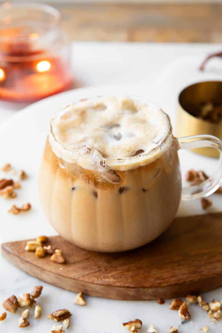 Maple pecan latte in a glass mug.