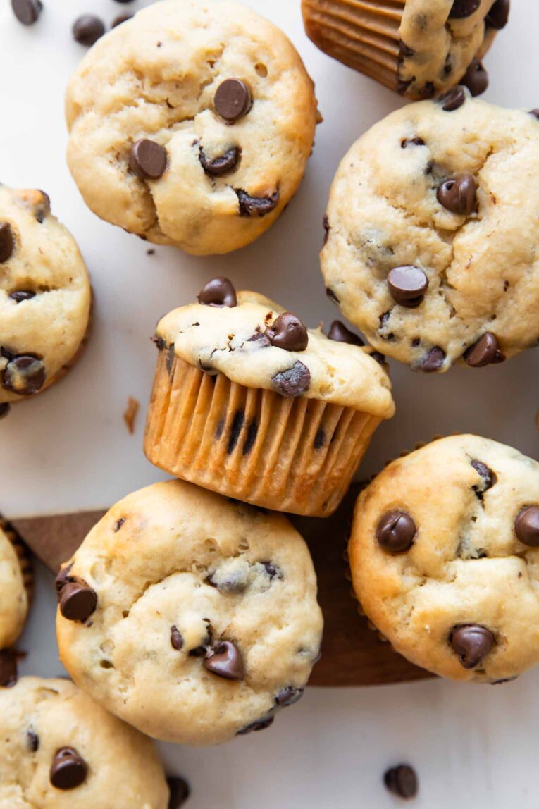 Banana chocolate chip muffins on a cutting board.
