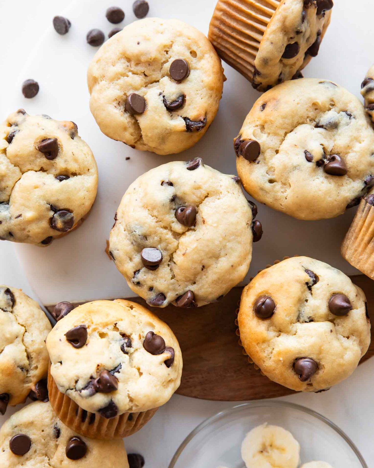 Banana chocolate chip muffins on a cutting board.