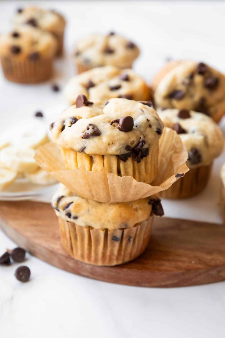 Two Banana chocolate chip muffins stacked on top of each other.