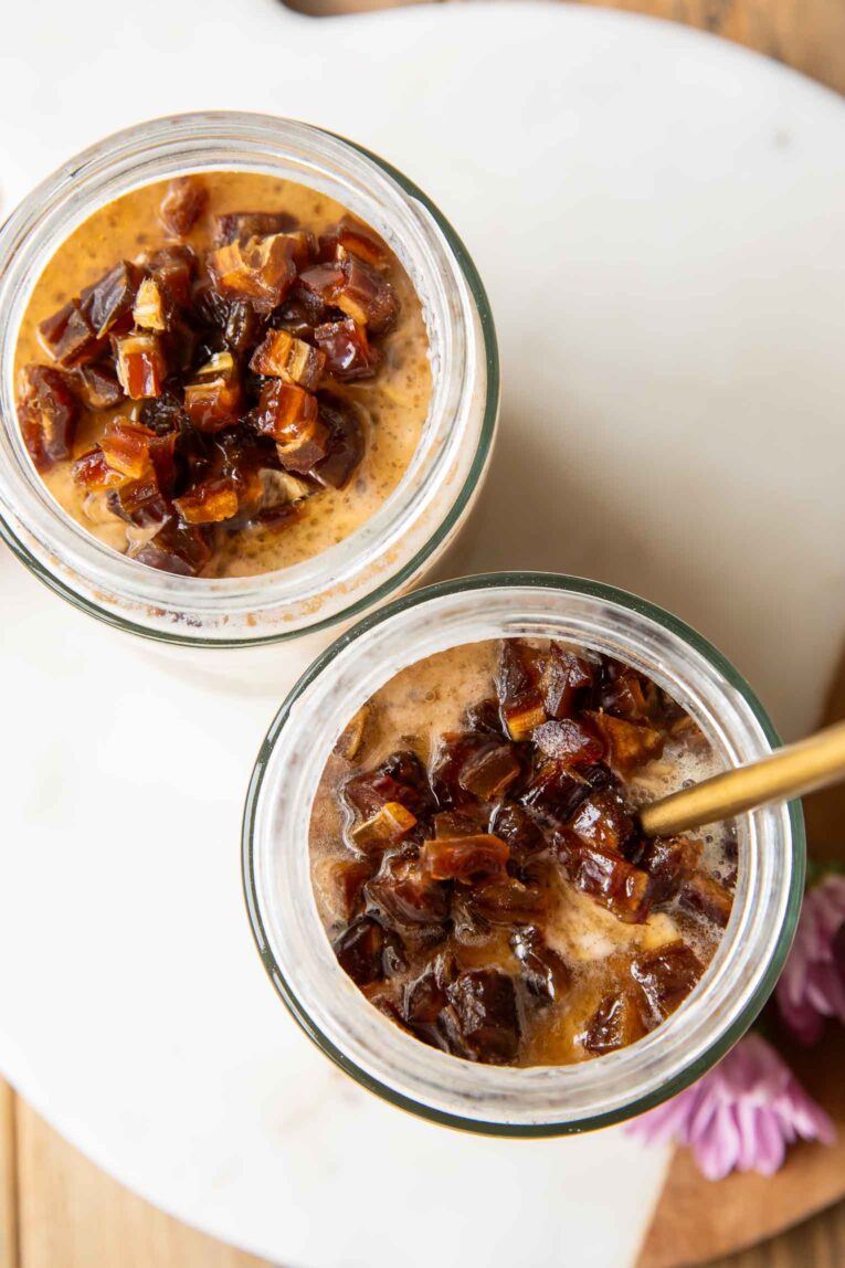 Top view Palm Springs Date Overnight Oats in two mason jars.