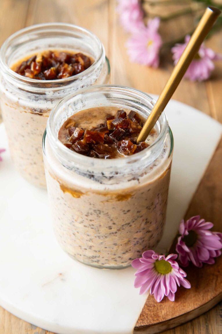 Angled view of Palm Springs Date Overnight Oats in two mason jars.