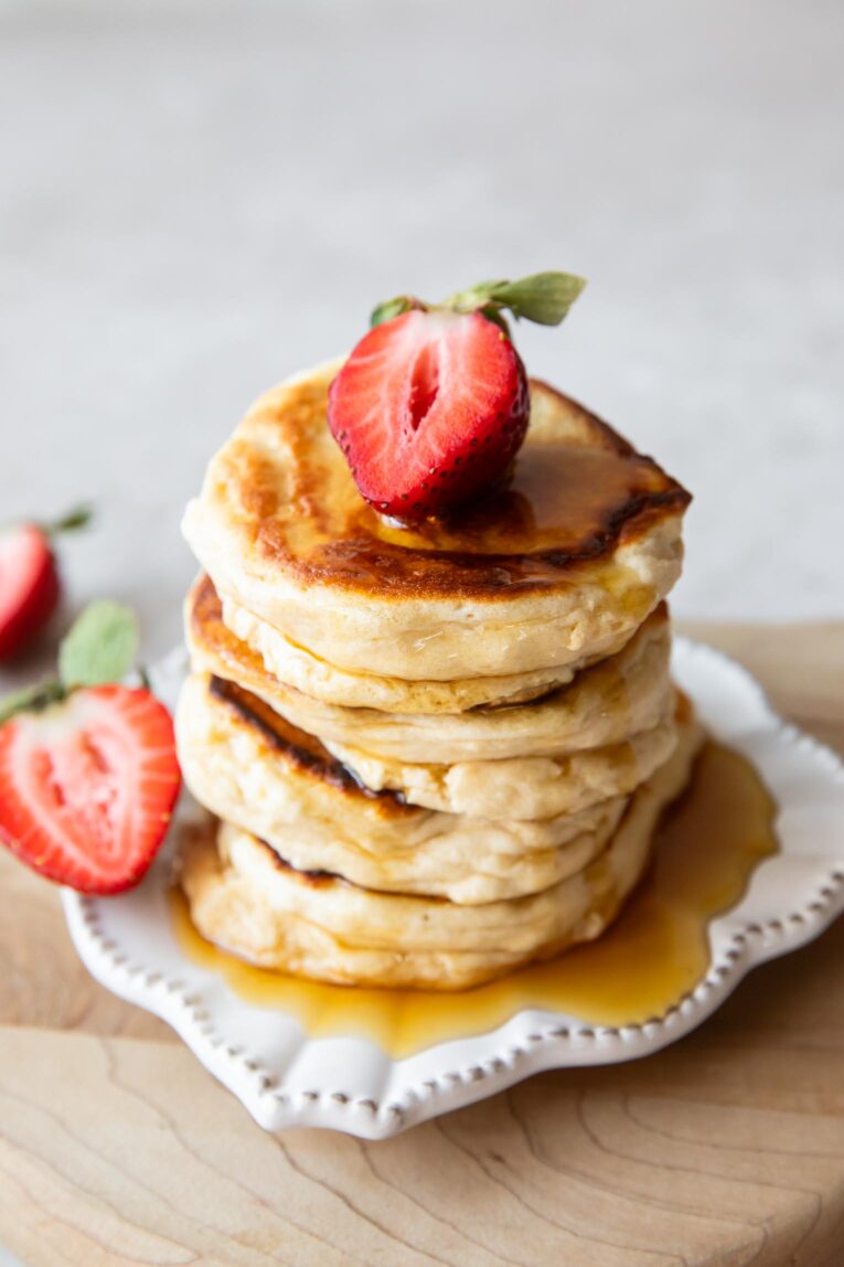 Angled image of A stack of Souffle Pancakes on a plate.