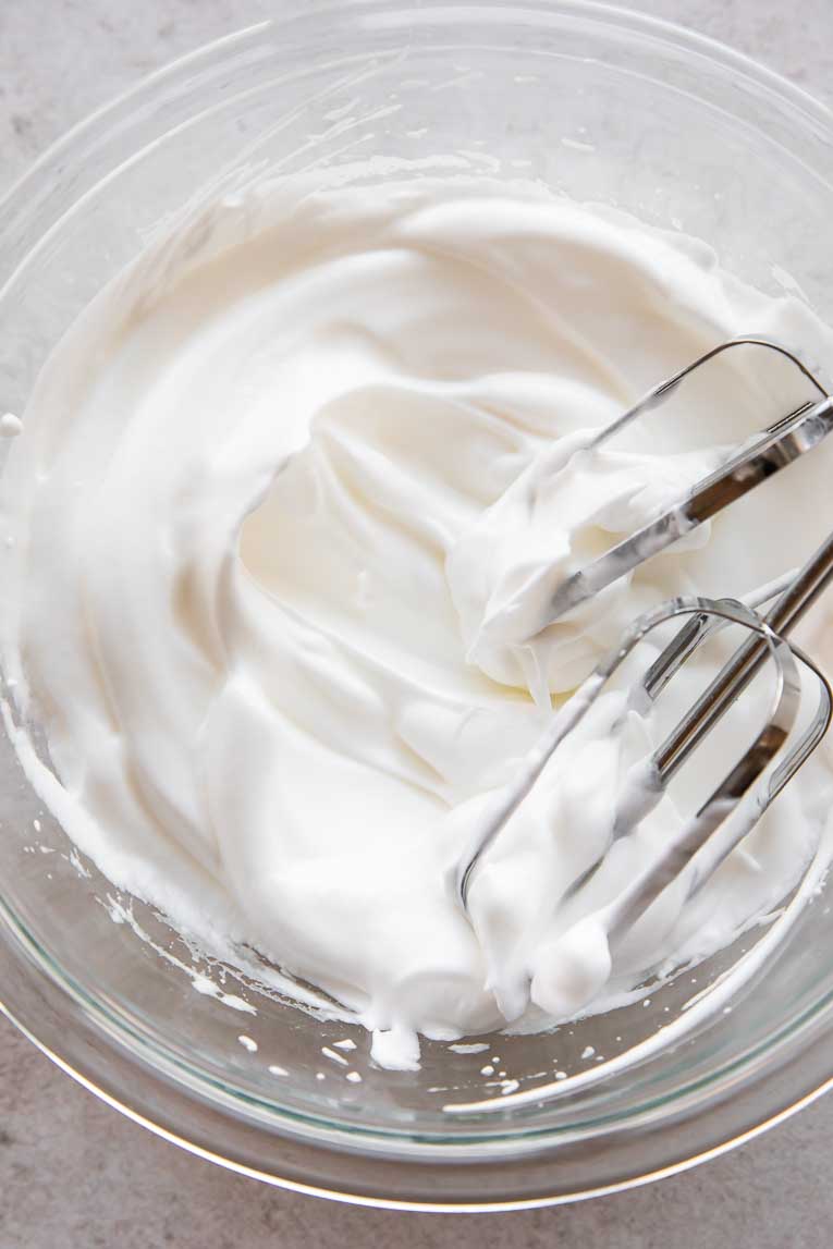 Egg whites beaten in a bowl.