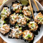 Salmon sushi cups with chopsticks.
