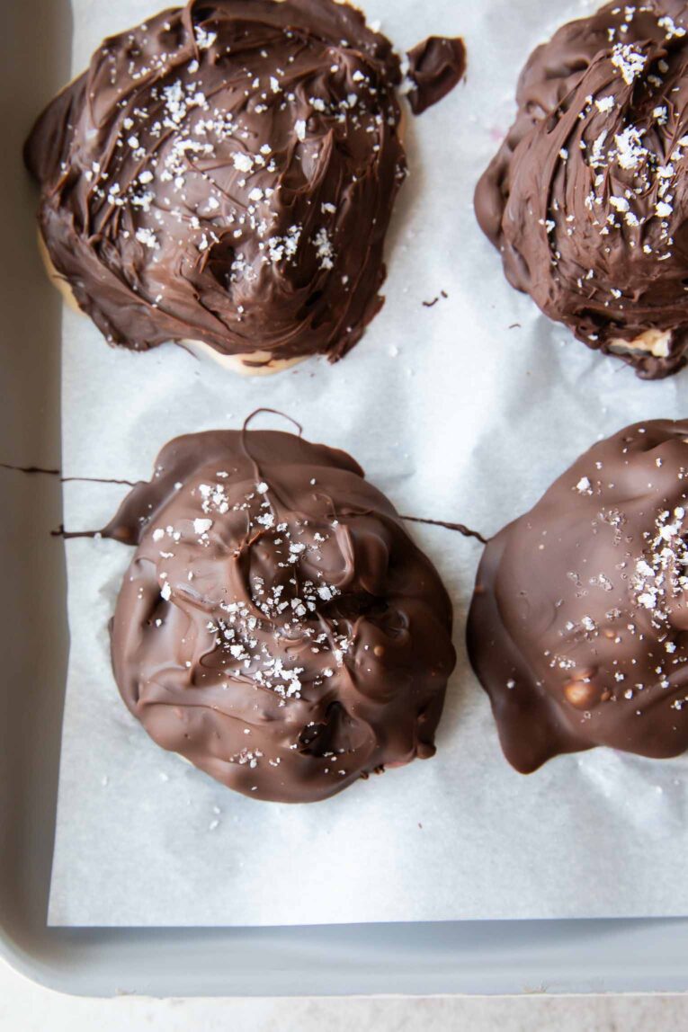 Strawberry chocolate yogurt bites on parchment paper.