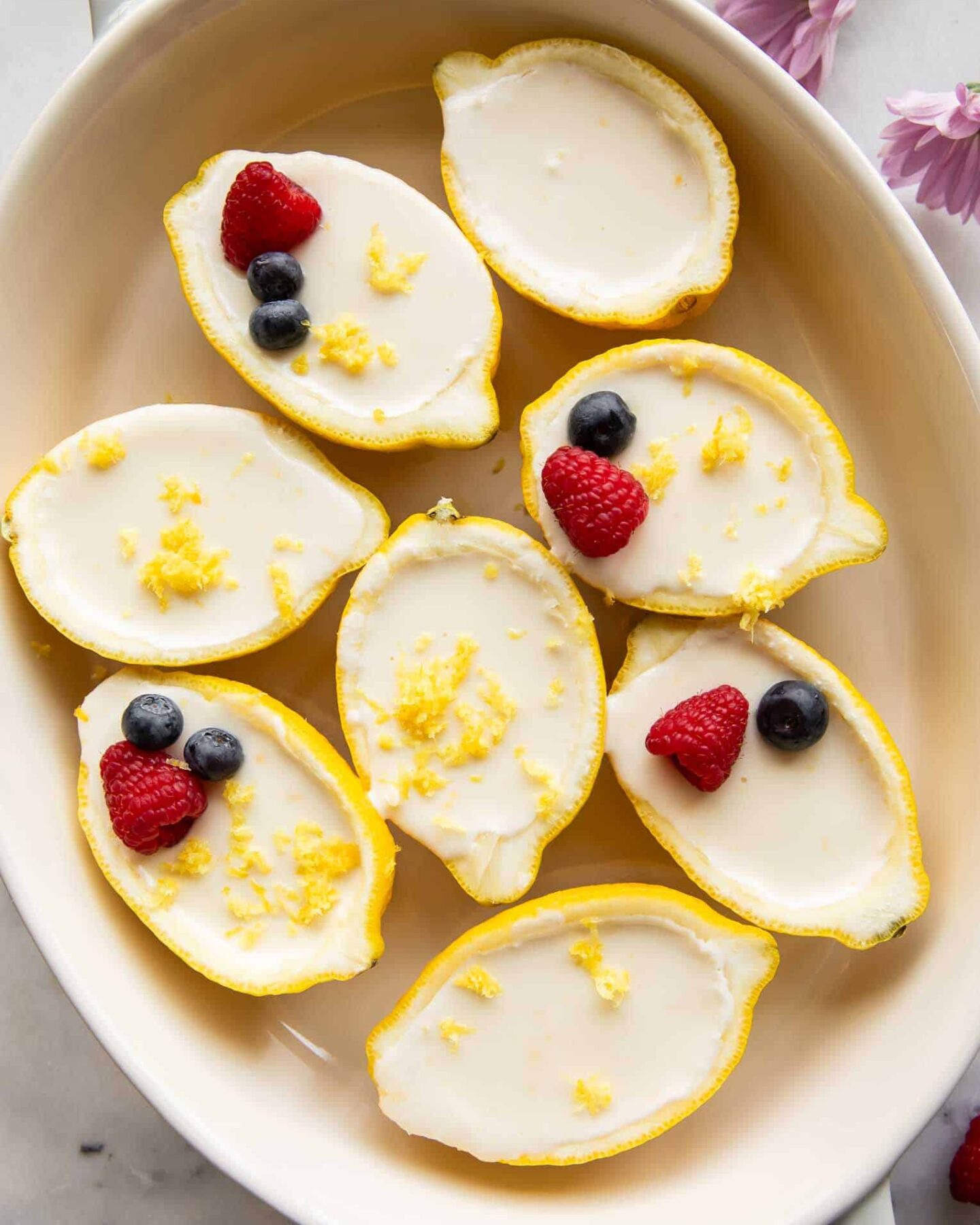 Lemon posset inside a lemon peel.