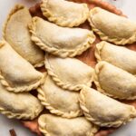 Nicaraguan Pastelitos on a wooden surface.