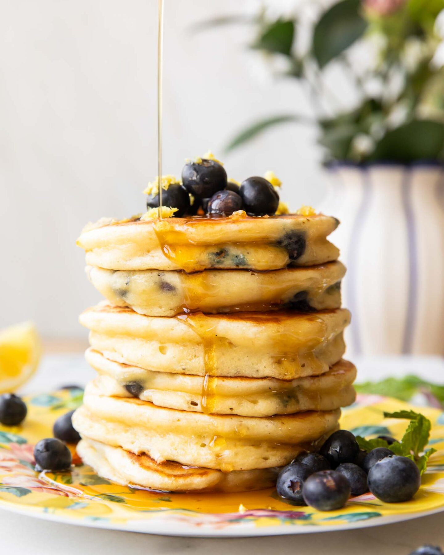 A stack of lemon blueberry muffins on a plate.