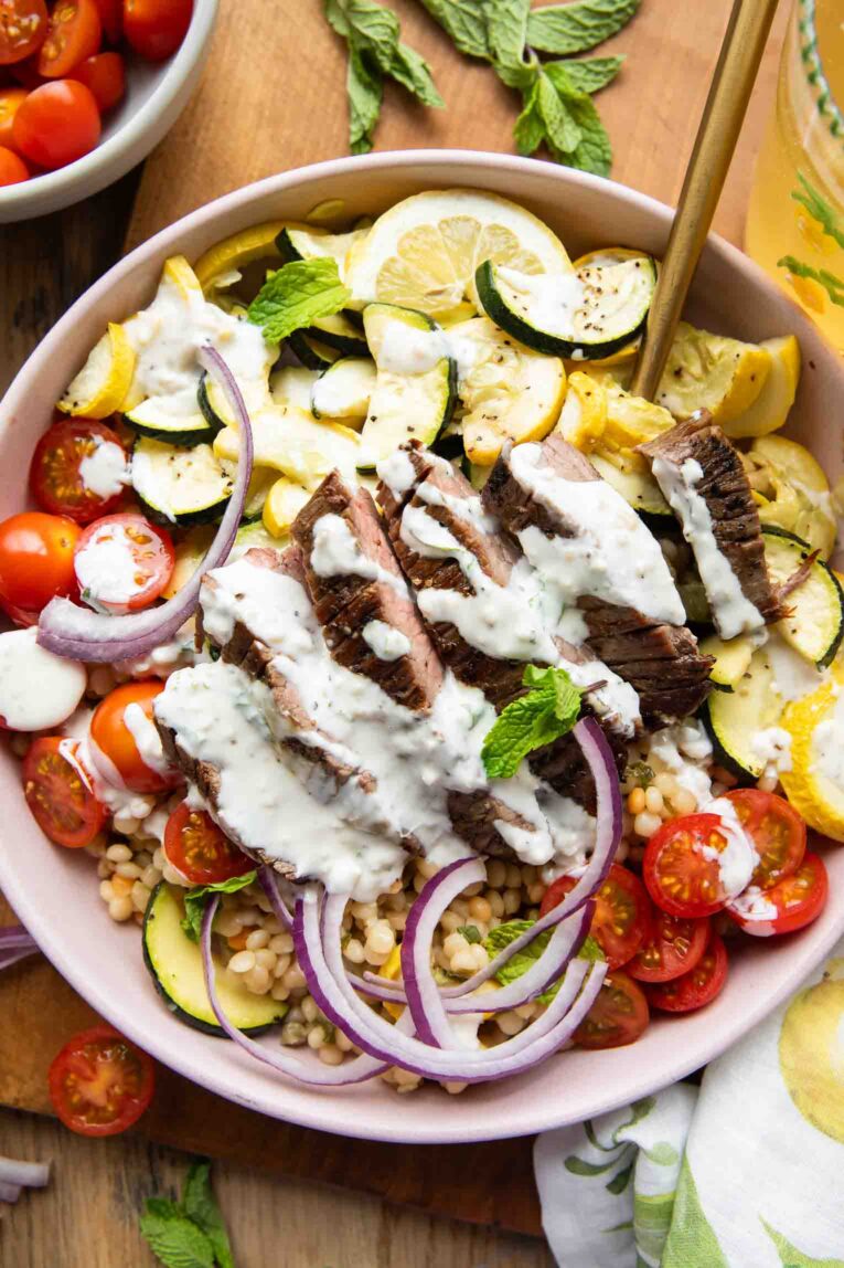 Steak Couscous Bowl on a cutting board.