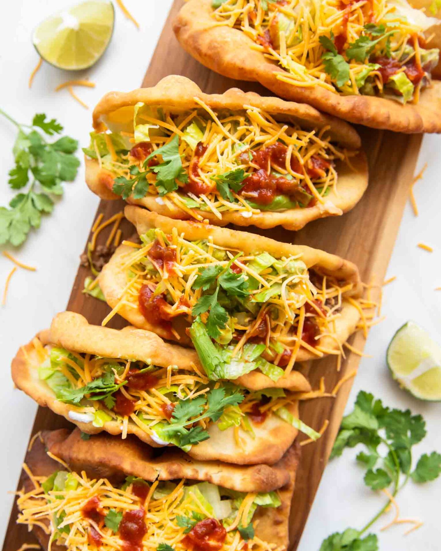 Top view of Taco Bell Chalupas on a cutting board.