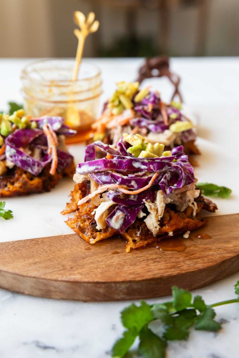 Hot honey sweet potato waffles on a cutting board.