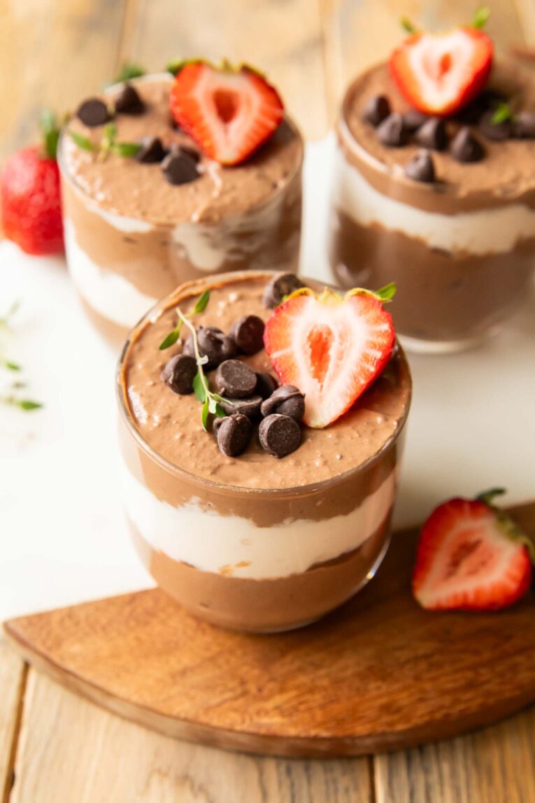 Chocolate Mousse Parfaits on a cuttings board.