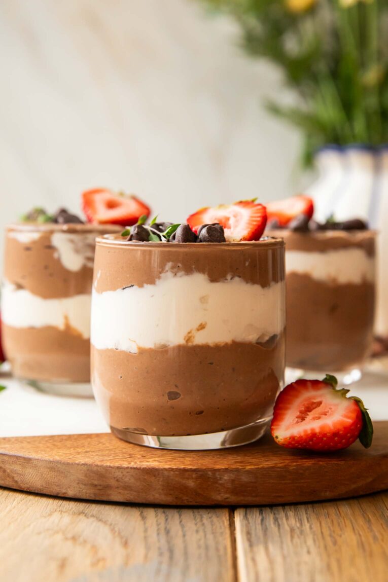 Chocolate Mousse Parfaits on a cuttings board.