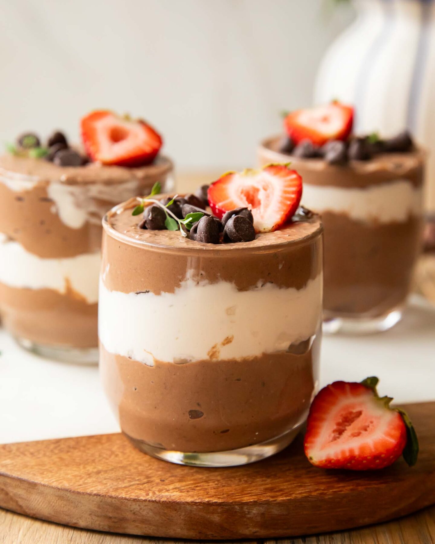 Chocolate Mousse Parfaits on a cuttings board.
