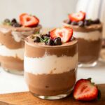 Chocolate Mousse Parfaits on a cuttings board.