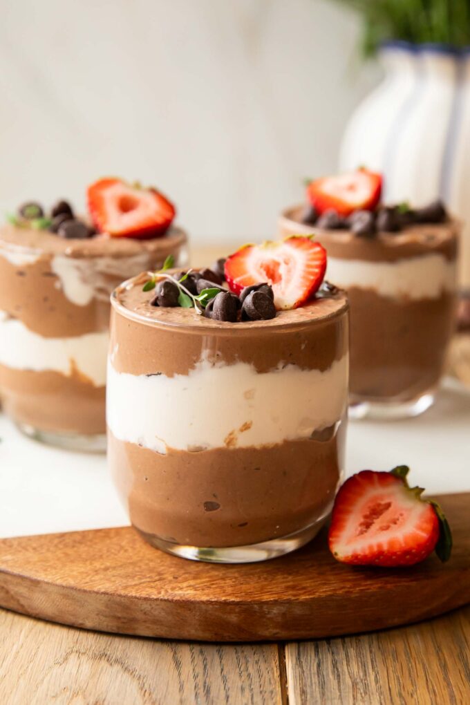 Chocolate Mousse Parfaits on a cuttings board.